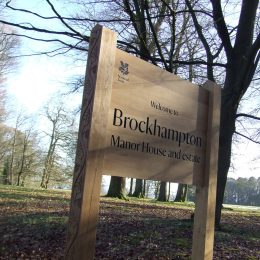 Woodsman welcome entrance sign